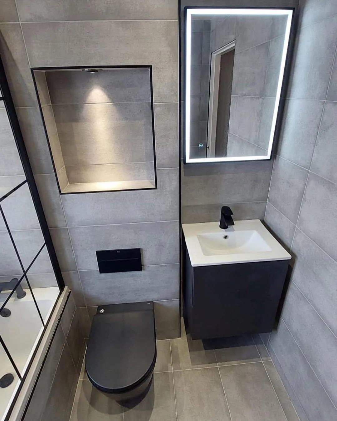 Stylish ensuite bathroom with glass shower enclosure and modern vanity